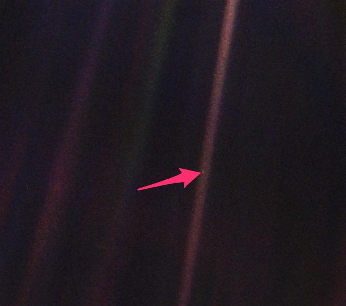 صورة نقطة زرقاء شاحبة مع سهم يشير إلى الأرض